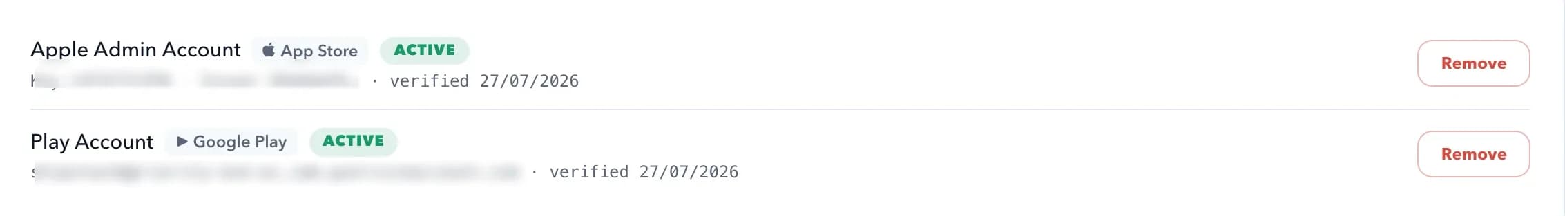 A close view of connected store accounts: an Apple App Store key and a Google Play service account, each marked active with its key identifier and verification date.